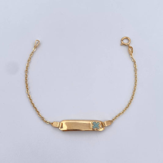 Pulso Bebe Aro Seguido 1.5gr / 14.2cm / 1mm Placa Rectangular Trebol Tornazol Oro Amarillo 18K $