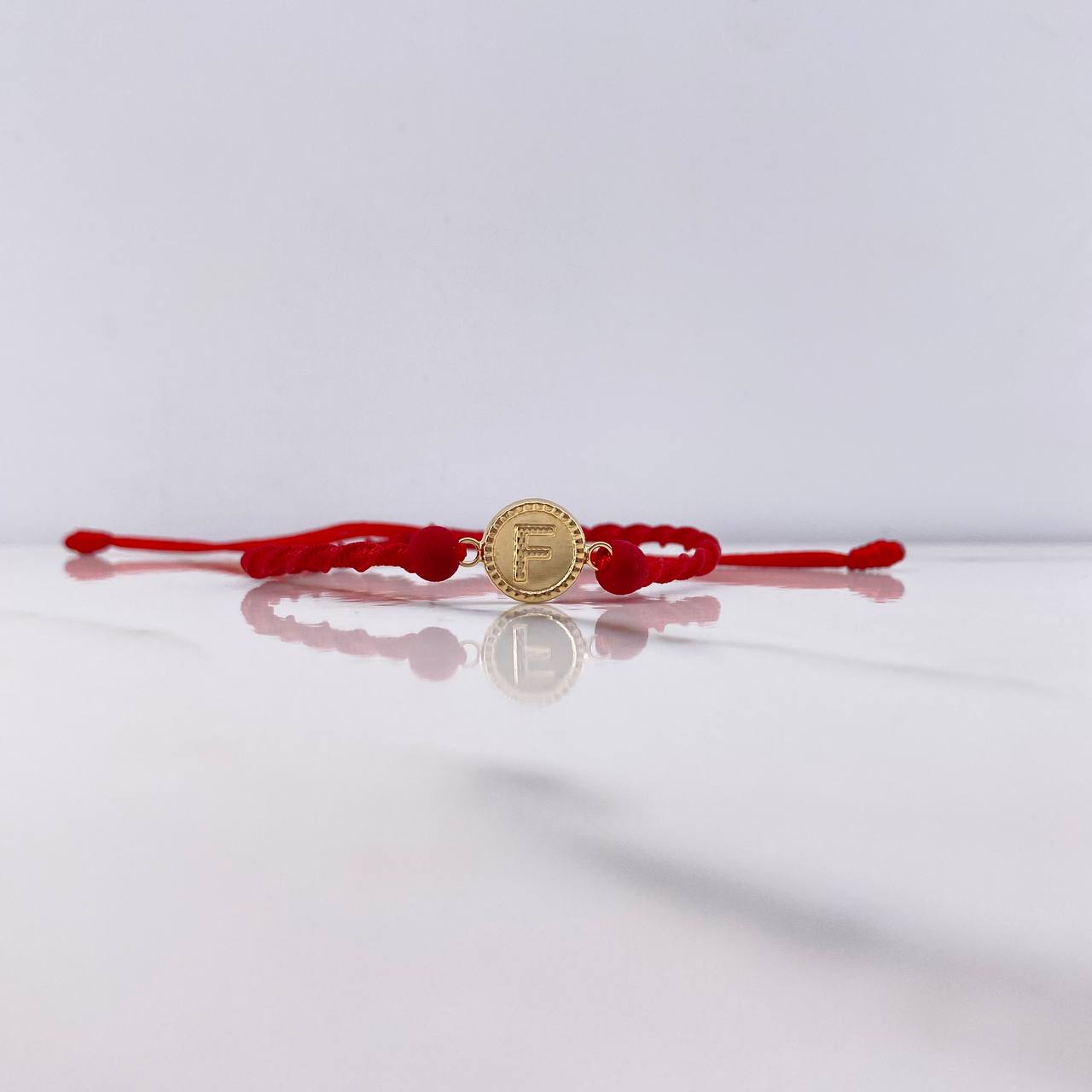 Pulsera Roja Herraje Letra F 0.55gr / 1.5cm / 5mm Troquelado Bolas Neoprenos Rojo Oro Amarillo $