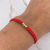 Pulsera Roja Bolas 0.15gr / 3mm Oro Amarillo $