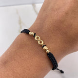 Pulsera Negra Herraje Infinito 0.95gr / 3mm-4mm Bolas Diamantadas Oro Amarillo $