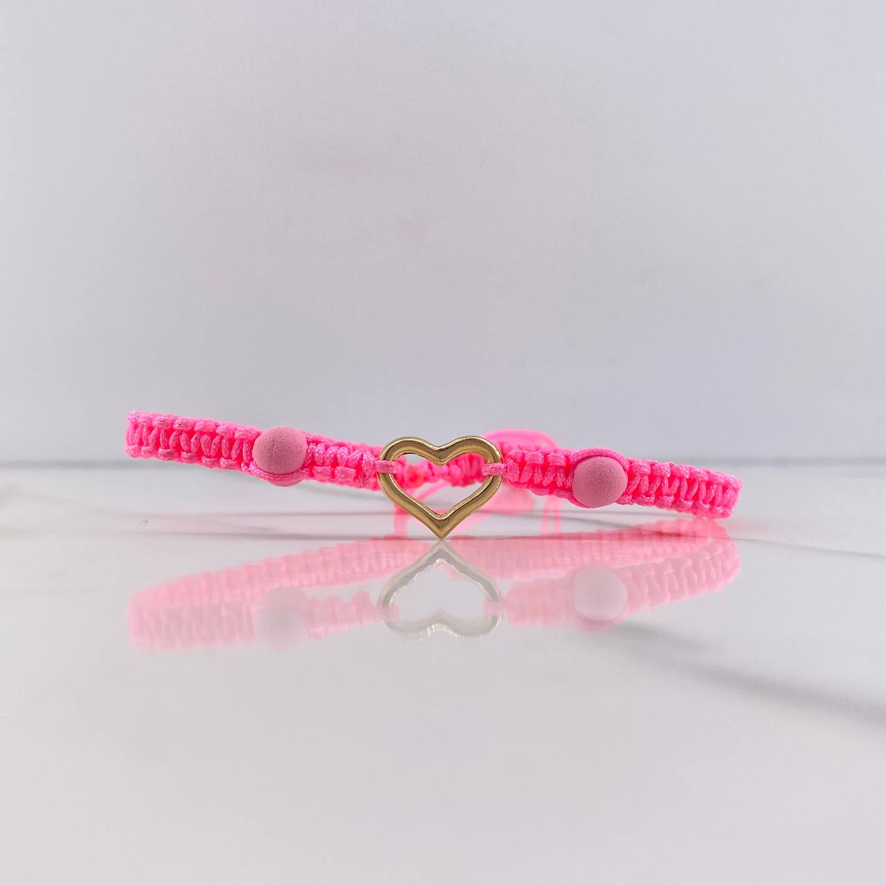 Pulsera Rosada Silueta Corazon 0.5gr / Bolas Neoprenos Rosadas Oro Amarillo $