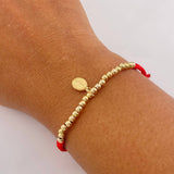 Pulsera Roja Virgen Milagrosa 1.3gr / 3mm Bolas Lisas Oro Amarillo $