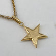 Dije Estrella  0.7gr / 2.5cm / Liso  Oro Amarillo $