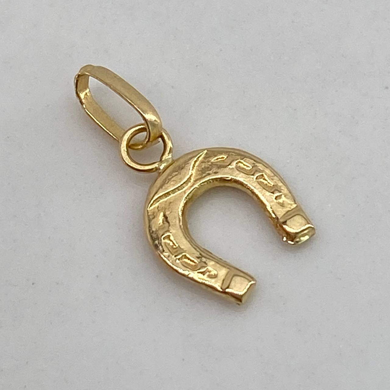 Dije Herradura  0.35gr / 1.5cm / Liso  Oro Amarillo $