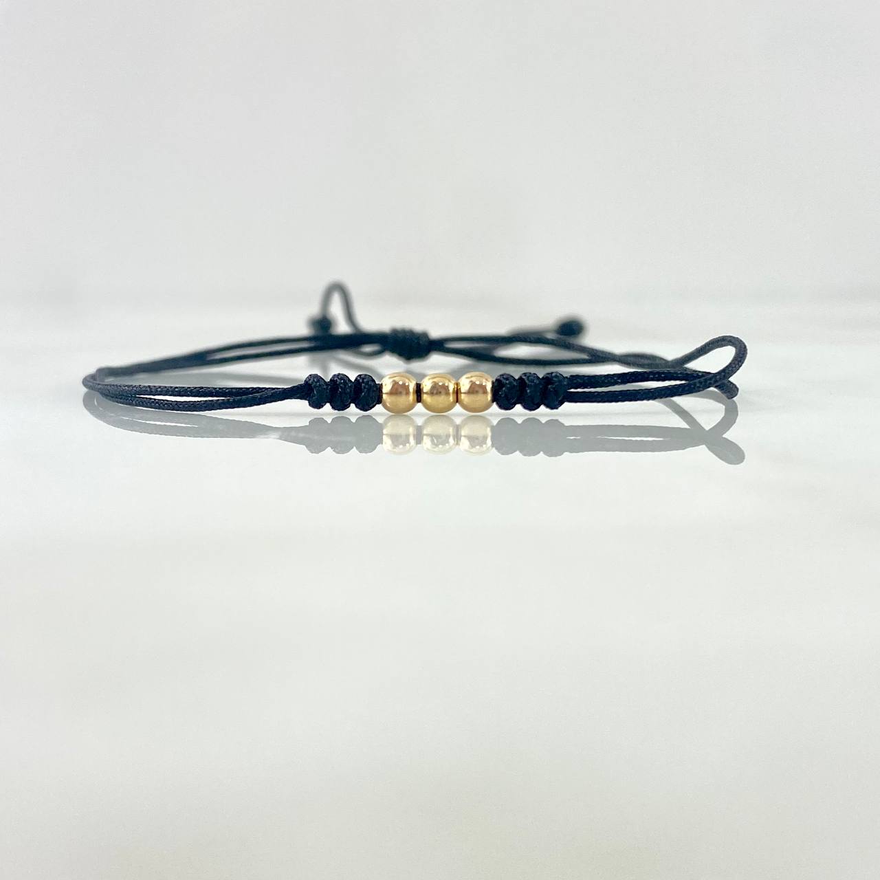 Pulsera Negra Trio Simil 0.2gr / 3mm Bolas Lisas 3 und Oro Amarillo ©