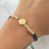 Pulsera Negra Herraje Letra A Circulo 1.8gr / 4mm Bolas Diamantadas 10 Und Oro Amarillo 18K