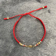 Pulsera GC 0.35gr Tres Oros Hilo Rojo